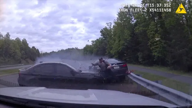 A police officer narrowly escapes a high-speed crash, in Fairfax County, Virginia, U.S., May 1, 2023, in this screen grab from a social media video. (Photo by Fairfax County Police Department via Facebook/Handout via Reuters)