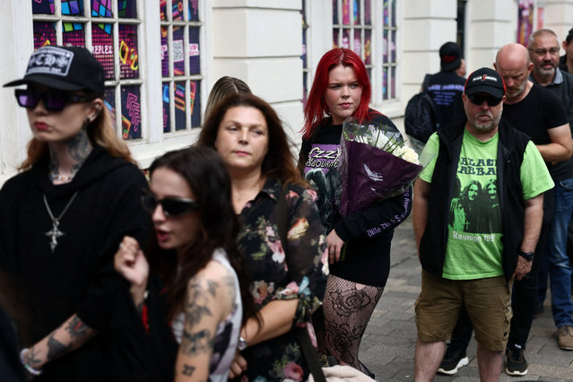 A woman queues to leave a floral tribute to Ozzy Osbourne, the former Black Sabbath frontman, in Birmingham, Britain, on July 30, 2025. (Photo by Jack Taylor/Reuters)
