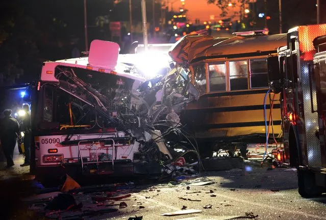 Fire department and rescue officials are at the scene of an early morning fatal collision between a school bus and a commuter bus Tuesday, November 1, 2016, in Baltimore. (Photo by Jeffrey F. Bill/Baltimore Sun via AP Photo)