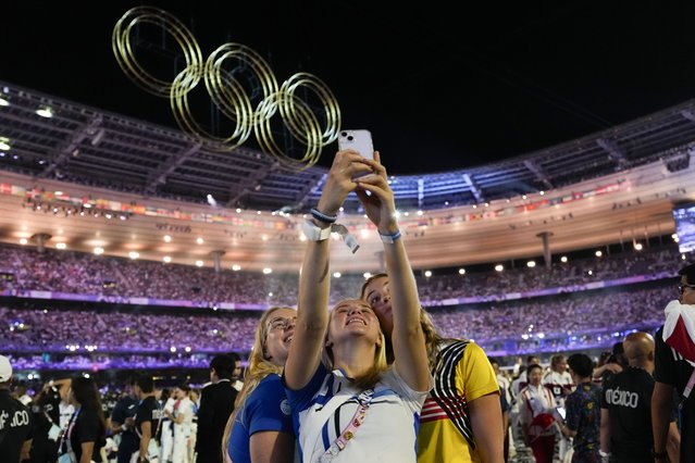 Athletes pose for a selfie during the 2024 Summer Olympics closing ceremony at the Stade de France, Monday, August 11, 2024, in Saint-Denis, France. (Photo by Ashley Landis/AP Photo)