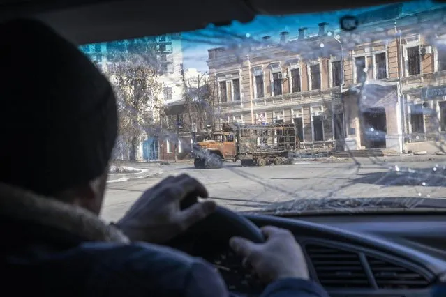 A destroyed car is seen near a damaged building at a front line discrict of Kharkiv, Ukraine’s second city and some 20 miles from the Russian border on March 27, 2022, amid Russian invasion of Ukraine. (Photo by Jack Hill/The Times)