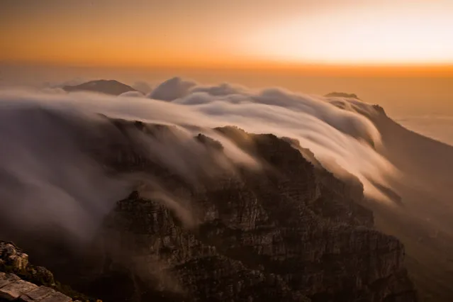 “Table Mountain's Cloudy Tablecloth”. This gorgeous phenomena of clouds pouring over the top of Table Mountain in Cape Town, South Africa, is what gave the mountain it's name. I was mesmerized by this stunning, slow-motion, waterfall effect and had to capture it with my camera...which I think is impossible to ever truly capture. (Photo and caption by Laura Grier/National Geographic Traveler Photo Contest)