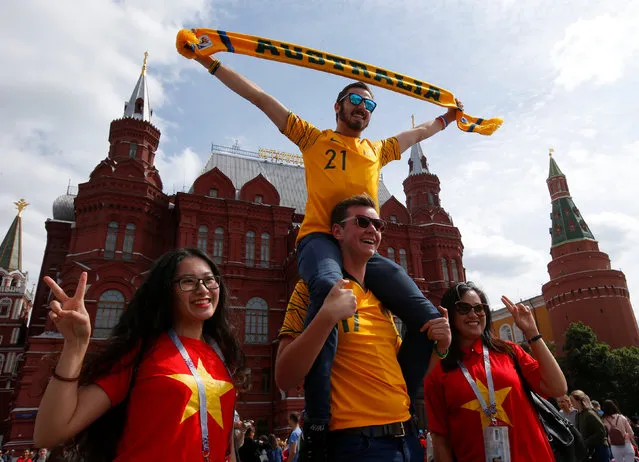 Supporters of the Australian national soccer team and Vietnamese tourists pose for a photo during a gathering on the first day of the 2018 FIFA World Cup in central Moscow, Russia June 14, 2018. (Photo by Sergei Karpukhin/Reuters)