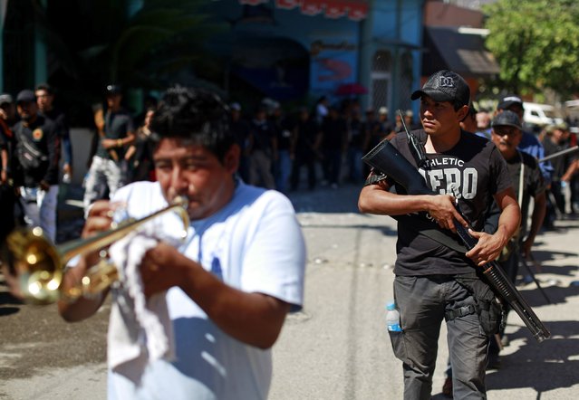 Members of the Community Police of the FUSDEG (United Front for the Security and Development of the State of Guerrero) take part in a march to mark the first anniversary of the force's operations in Ocotito, January 23, 2015. (Photo by Jorge Dan Lopez/Reuters)