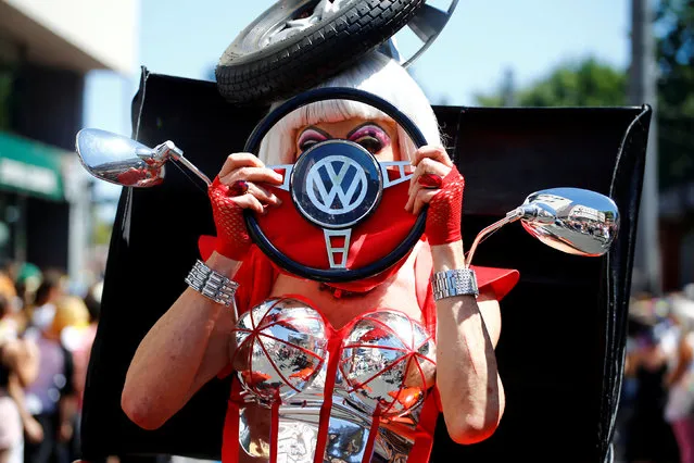 A reveller wearing a costume made out of pieces from a Volkswagen Beetle car takes part in the annual Christopher Street Day gay pride parade in Cologne, Germany July 8, 2018. (Photo by Wolfgang Rattay/Reuters)