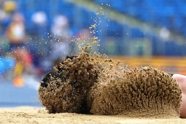 Turkey's Ecem Calagan lands in the sand after sustaining an injury during the Women's Long Jump during the European Games Athletics Championships at the Silesian Stadium in Chorzow, Poland on June 25, 2023. (Photo by Aleksandra Szmigiel/Reuters)