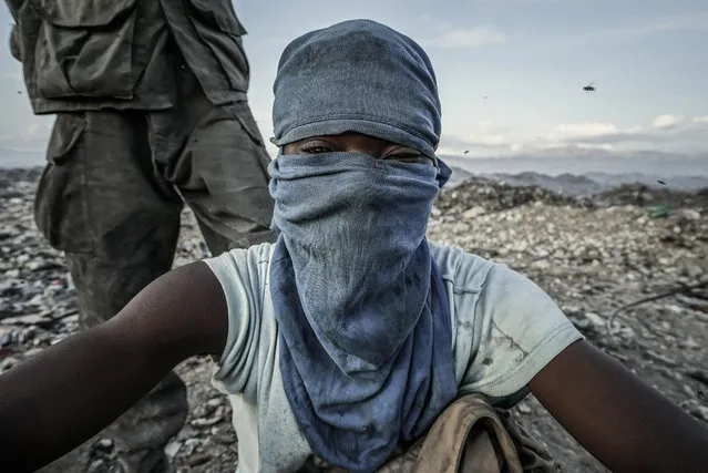 In a 200-acre-plus dump 5 kilometers north of Haiti’s capital, Port-au-Prince, hundreds of men, women and children scavenge day and night through the burning wasteland. They earn $12 to $15 a day – on a good day – for recycling plastics as well as clothing, household items and aluminum (for smelting). Some 5,000 tons of waste is created each day in the Port-au-Prince area. (Photo and caption by Giles Clarke/Getty Images Reportage)