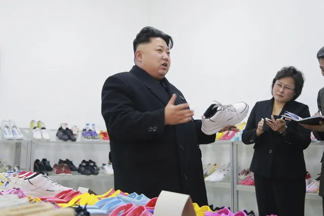 North Korean leader Kim Jong Un (L) provides field guidance to the Ryuwon Shoes Factory in this undated photo released by North Korea's Korean Central News Agency (KCNA) in Pyongyang January 21, 2015. (Photo by Reuters/KCNA)