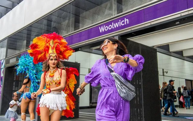 Samba dancers outside Woolwich station celebrate the opening of the Elizabeth Line in London, England on May 23, 2022. Originally due to open in December 2018, the £18.8bn railway links Reading and Essex via central London. (Photo by Jill Mead/The Guardian)