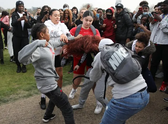 Women scuffle during a demonstration to mark the informal cannabis holiday, 4/20, in Hyde Park, London, Britain, April 20, 2021. (Photo by Tom Nicholson/Reuters)