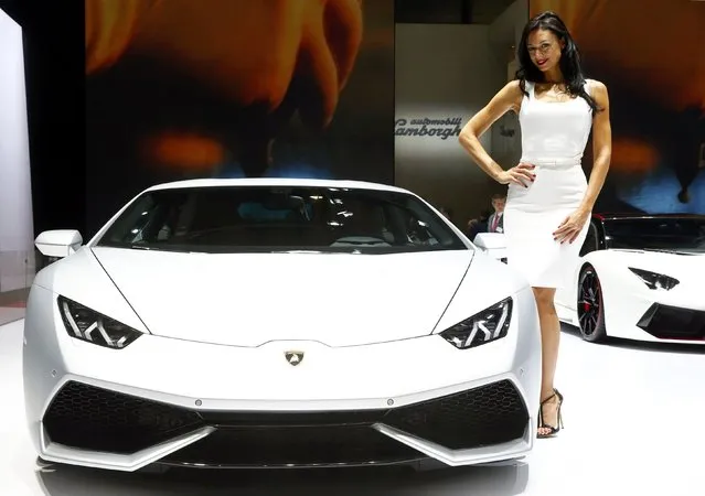 A model poses next to a Lamborghini Aventador LP 700-4 sports car during the second press day ahead of the 85th International Motor Show in Geneva March 4, 2015.  REUTERS/Arnd Wiegmann   
