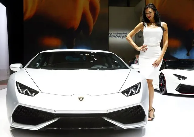 A model poses next to a Lamborghini Aventador LP 700-4 sports car during the second press day ahead of the 85th International Motor Show in Geneva March 4, 2015. REUTERS/Arnd Wiegmann