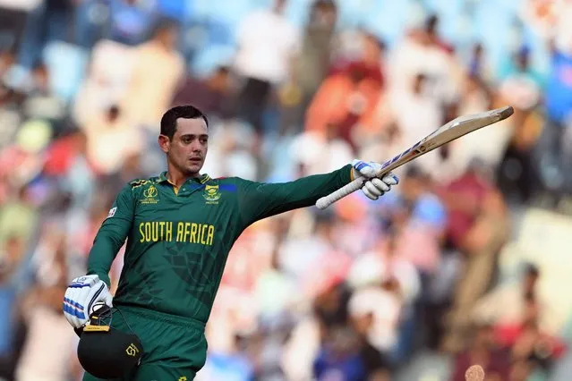 South Africa's Quinton de Kock celebrates after scoring a century (100 runs) during the 2023 ICC Men's Cricket World Cup one-day international (ODI) match between Australia and South Africa at the Ekana Cricket Stadium in Lucknow on October 12, 2023. (Photo by Tauseef Mustafa/AFP Photo)