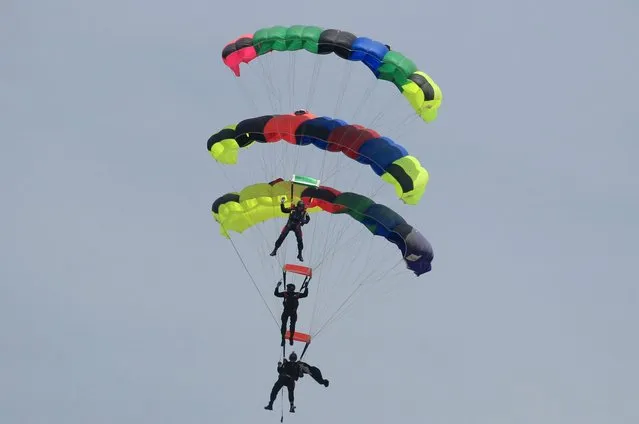 Pakistani paratroopers perform during the Pakistan Day parade in Islamabad March 23, 2015. Pakistan held its first Republic Day parade in seven years on Monday, full of flag-waving pomp and aerial military expertise, a symbolic show of strength in the war against the Taliban months after a militant attack on a school killed 132 children. (Photo by Faisal Mahmood/Reuters)