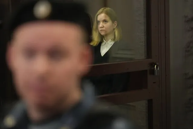 Darya Trepova, a suspect in a bombing that killed a well-known Russian military blogger, stands in a glass cage as she attends a court hearing in the 1st Western District Military Court, in St. Petersburg, Russia, Wednesday, November 15, 2023. A military court in St Petersburg starts a trial against a 26-year-old woman Darya Trepova who is charged with terrorism after an attack at a St. Petersburg cafe that killed Russian military blogger Vladlen Tatarsky. (Photo by Dmitri Lovetsky/AP Photo)