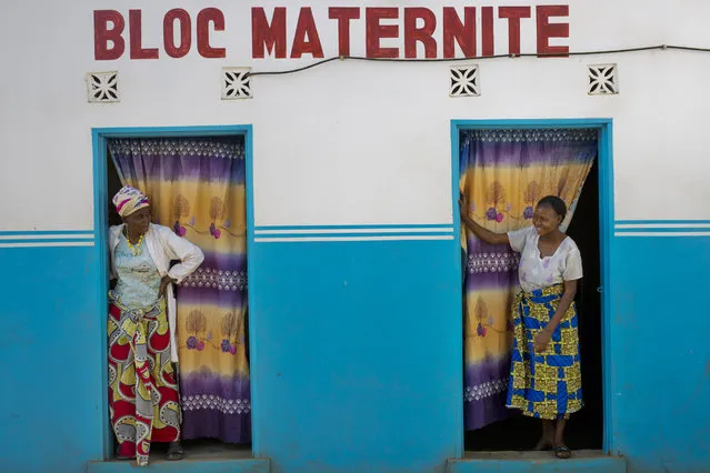 Alice Kabuya, 20, right, looks at a clinic employee at the Masaidizi Health Center in Lubumbashi, Democratic Republic of the Congo on Tuesday, August 14, 2018. Kabuya gave birth to her daughter at the facility but is unable to pay the $150 medical bill. She said the clinic's doors were locked every afternoon and that she could not walk more than about 10 feet outside before being reprimanded by nurses. (Photo by Jerome Delay/AP Photo)