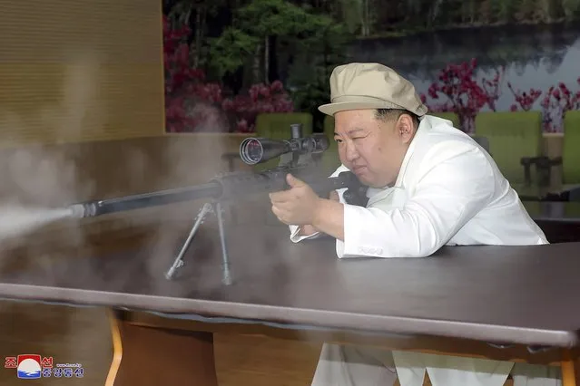In this undated photo provided by the North Korean government, North Korean leader Kim Jong Un tries a weapon during his three-day inspection from Aug. 3 until August 5, 2023 at major munitions factories in North Korea. Independent journalists were not given access to cover the event depicted in this image distributed by the North Korean government. The content of this image is as provided and cannot be independently verified. Korean language watermark on image as provided by source reads: “KCNA” which is the abbreviation for Korean Central News Agency. (Photo by Korean Central News Agency/Korea News Service via AP Photo)