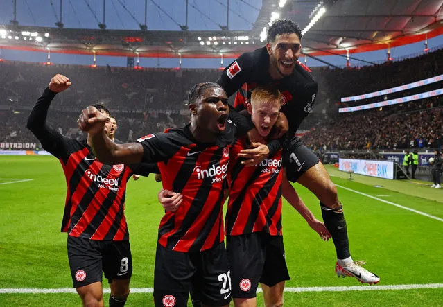 Eintracht Frankfurt's Hugo Larsson celebrates with Eric Junior Dina Ebimbe and Omar Marmoush after scoring their third goal during the German first division Bundesliga football match between Eintracht Frankfurt and FC Bayern Munich in Frankfurt, western Germany on December 9, 2023. (Photo by Kai Pfaffenbach/Reuters)