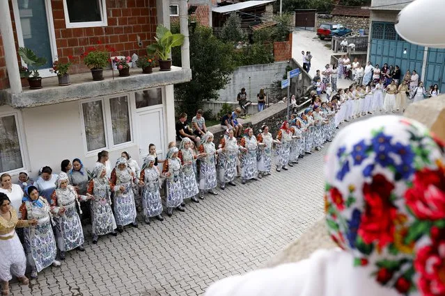 Kosovar Bosnian women are dancing during the traditional wedding ceremony in the village of Donje Ljubinje, Kosovo, 14 August 2021. (Photo by Valdrin Xhemaj/EPA/EFE)