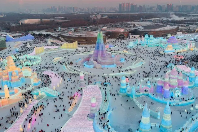This aerial photo shows tourists visiting the Harbin Ice-Snow World in Harbin, northeast China's Heilongjiang Province, December 18, 2023. The renowned Harbin Ice-Snow World opened to the public on Monday. Over 1,000 appealing ice and snow landscapes and sculptures have been built in the park for people to enjoy. The park aims to integrate arts, culture, performance, architecture and sports to showcase the charm of ice and snow. (Photo by Xinhua News Agency/Rex Features/Shutterstock)