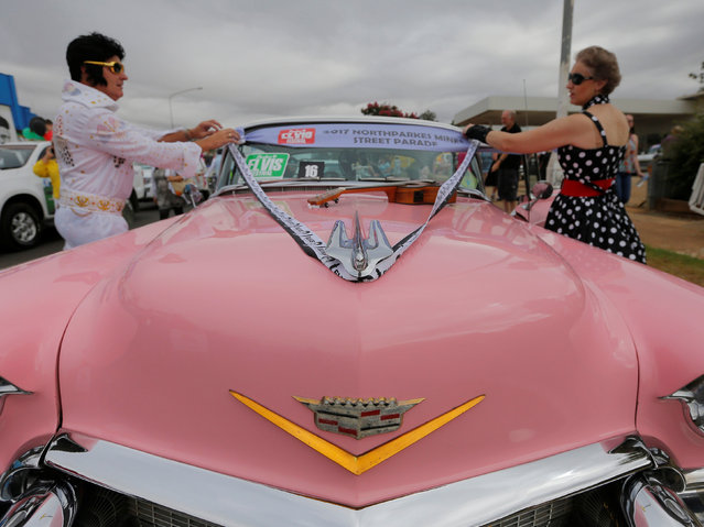 A pink Cadillac is prepared by a man dressed as Elvis Presley before a street parade at the 25th annual Parkes Elvis Festival in the rural Australian town of Parkes, west of Sydney, January 14, 2017. (Photo by Jason Reed/Reuters)