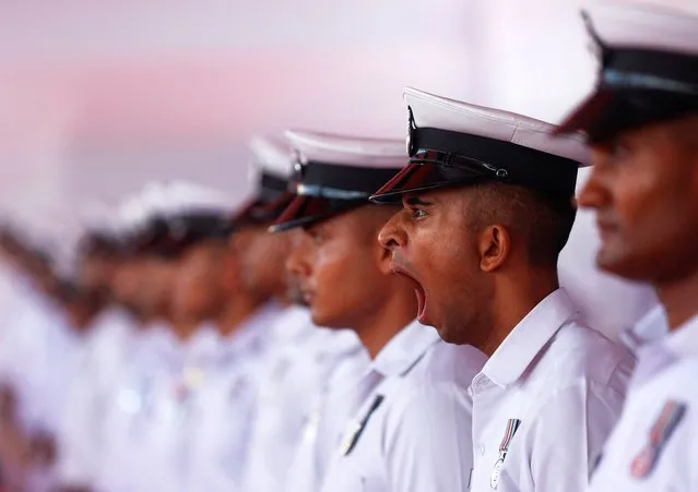 A navy personnel yawns before the commissioning ceremony of INS Imphal, a stealth guided missile destroyer and the third warship of Project-15B, at the Naval Dockyard, in Mumbai, India on December 26, 2023. (Photo by Francis Mascarenhas/Reuters)