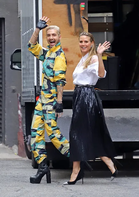 Heidi Klum and future brother-in-law Bill Kaulitz stay in high spirits as they brave the rain to film scenes for Germany's Next Top Model in Downtown LA on February 13, 2019. Heidi Klum stayed bundled in a giant creme fur-coat, umbrella and a can of Coke showing off her huge sparkling engagement ring from Bill.s twin brother and band-mate Tom Kaulitz. (Photo by Splash News and Pictures)
