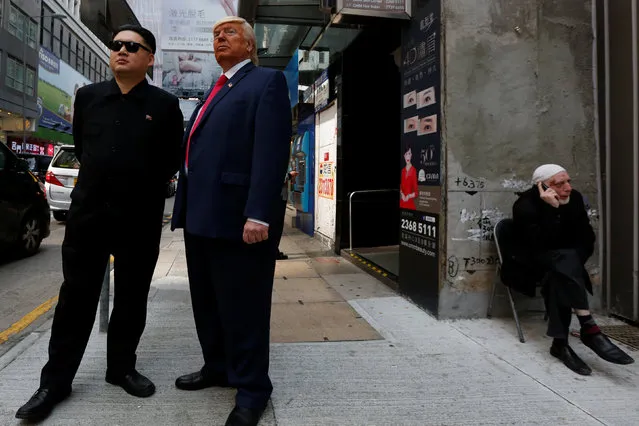 Howard, 37, an Australian-Chinese who is impersonating North Korean leader Kim Jong-un, and Dennis Alan of Chicago, 66, who is impersonating U.S. President Donald Trump, pose on a street in Hong Kong, China January 25, 2017. (Photo by Bobby Yip/Reuters)
