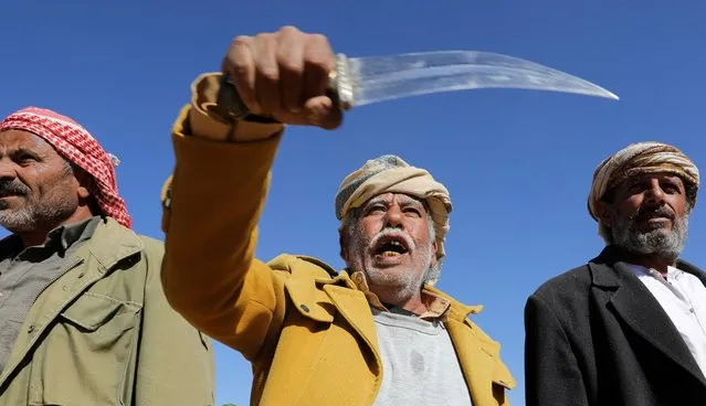 A tribal supporter of Yemen's Houthis hold his traditional dagger, or jambiya, during a protest against recent U.S.-led strikes on Houthi targets, near Sanaa, Yemen ob January 14, 2024. (Photo by Khaled Abdullah/Reuters)