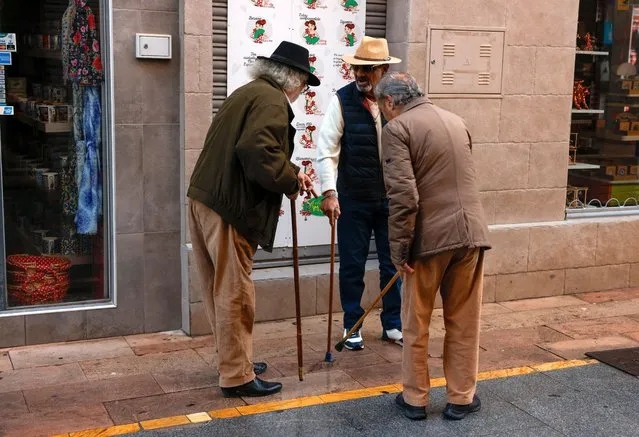 Pensioners compare their walking sticks in a street in Ronda, Spain on January 30, 2024. (Photo by Jon Nazca/Reuters)