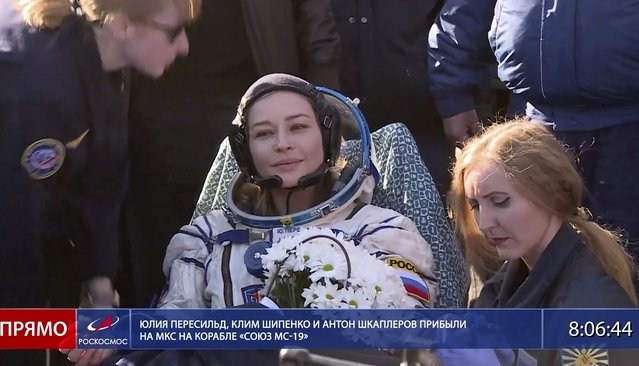 In this photo taken from video footage released by Roscosmos Space Agency, actress Yulia Peresild sits in a chair shortly after the landing of the Russian Soyuz MS-18 space capsule, southeast of the Kazakh town of Zhezkazgan, Kazakhstan, Sunday, October 17, 2021. The Soyuz MS-18 capsule landed upright in the steppes of Kazakhstan on Sunday with cosmonaut Oleg Novitskiy, actress Yulia Peresild and film director Klim Shipenko aboard after a 3 1/2-hour trip from the International Space Station. (Photo by Roscosmos Space Agency via AP Photo)