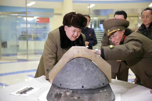 North Korean leader Kim Jong Un looks at a rocket warhead tip after a simulated test of atmospheric re-entry of a ballistic missile, at an unidentified location in this undated photo released by North Korea's Korean Central News Agency (KCNA) in Pyongyang on March 15, 2016. (Photo by Reuters/KCNA)