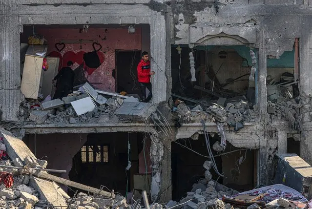 Palestinians inspect the damage in the rubble of a building where two hostages were reportedly held before being rescued during an operation by Israeli security forcess in Rafah, on the southern Gaza Strip on February 12, 2024, amid ongoing battles between Israel and the militant group Hamas. Israel announced on February 12 the rescue of two hostages in the southern Gaza city of Rafah, where the Hamas-run health ministry said “around 100” Palestinians including children were killed in heavy overnight air strikes. (Photo by Said Khatib/AFP Photo)
