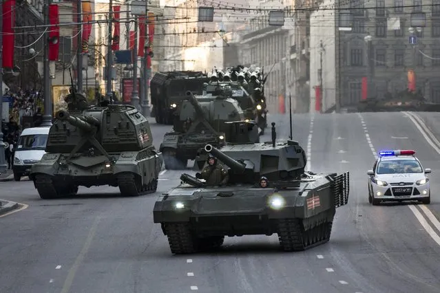 New Russian military vehicles including the new Russian T-14 Armata tank, center foreground, make their way to Red Square during a rehearsal for the Victory Day military parade which will take place at Moscow's Red Square on May 9 to celebrate 70 years after the victory in WWII, in Moscow, Russia, Monday, May 4, 2015. (Photo by Alexander Zemlianichenko/AP Photo)