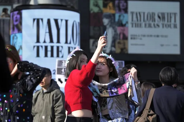 Women pose for a selfie before Taylor Swift's concert at Tokyo Dome in Tokyo, Saturday,February 10, 2024. (Photo by Hiro Komae/AP Photo)