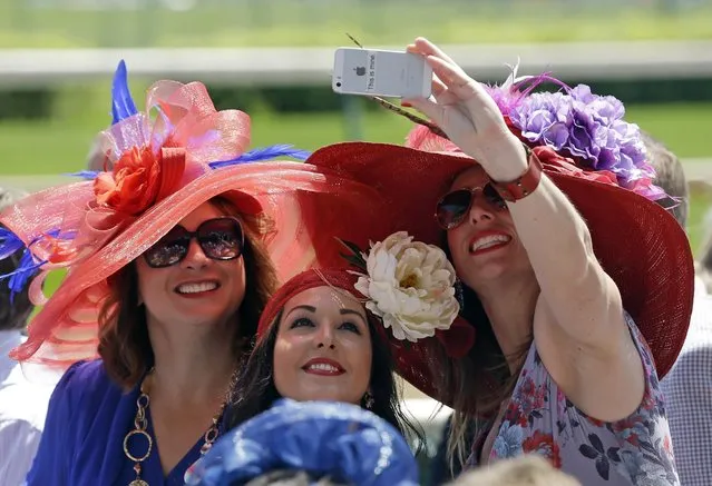Fans shoot a selfie before the 141st running of the Kentucky Oaks horse race at Churchill Downs Friday, May 1, 2015, in Louisville, Ky. (Photo by Darron Cummings/AP Photo)