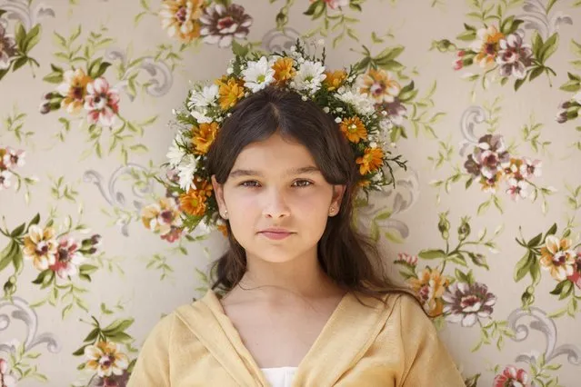 A “Maya” girl sits in an altar during the traditional celebration of “Las Mayas” on the streets in Madrid, Spain Sunday, May 10, 2015. The festivity of the Maya comes from pagan rites and dates from the medieval age, appearing in ancient documents. It takes place every year in the beginning of May and celebrates the beginning of the spring. (Photo by Daniel Ochoa de Olza/AP Photo)