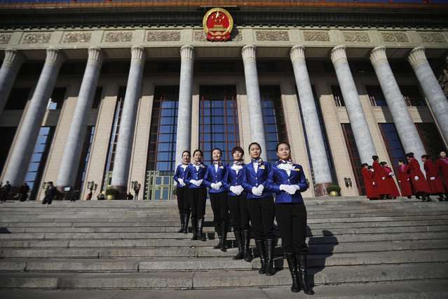 Chinese stewardesses pose for photographs in front of the Great Hall of the People during the opening session of the National Peoples Congress (NPC) in Beijing, China, 05 March 2014. (Photo by Diego Azubel/EPA)