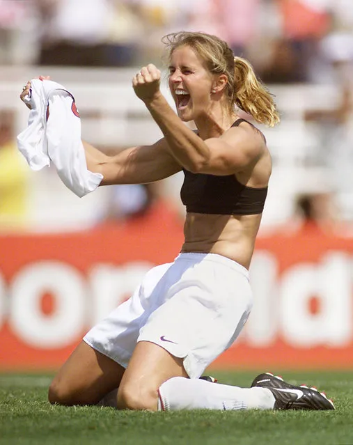 Brandi Chastain of the US celebrates after kicking the winning penalty kick to win the 1999 Women's World Cup final against China 10 July 1999 at the Rose Bowl in Pasadena. The US won 5-4 on penalties. (Photo by Roberto Schmidt/AFP Photo)