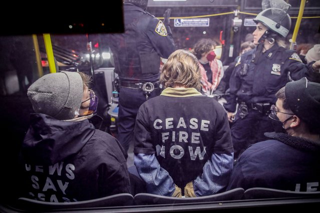 Police officers arrest protestors near the home of US Senate Majority Leader Chuck Schumer in the Brooklyn borough of New York during a demonstration by pro-Palestinian Jewish groups on the second night of Passover calling on Schumer to stop arming Israel amid its retaliatory assault on the Gaza Strip on April 23, 2024. (Photo by Kena Betancur/AFP Photo)