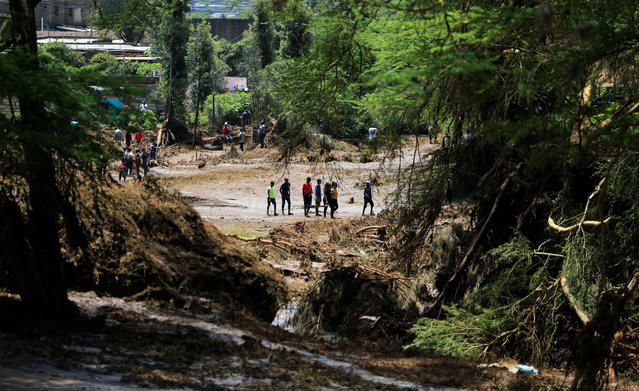 Residents walk in search of missing people after heavy flash floods wiped out several homes when a dam burst, following heavy rains in Kamuchiri village of Mai Mahiu, Nakuru County, Kenya on April 29, 2024. (Photo by Thomas Mukoya/Reuters)