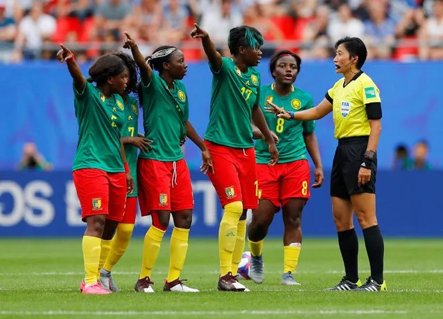 Players of Cameroon speak with referee Qin Liang during the 2019 FIFA Women's World Cup France Round Of 16 match between England and Cameroon at Stade du Hainaut on June 23, 2019 in Valenciennes, France. (Photo by Phil Noble/Reuters)