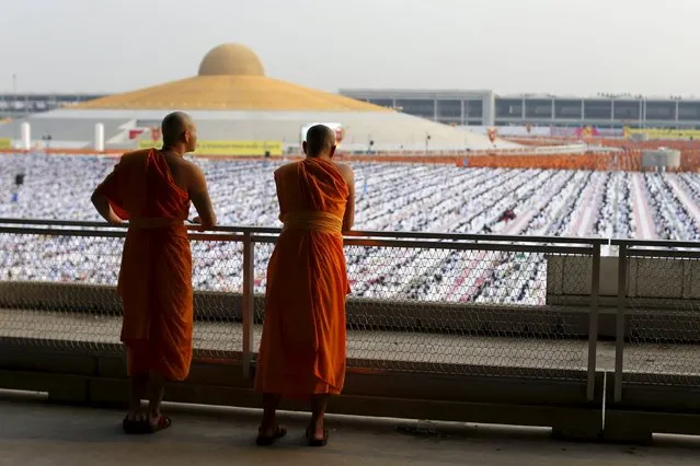 Buddhist monks and novices gather to receive alms at Wat Phra Dhammakaya temple, in what organizers said was a meeting of over 100,000 monks in Pathum Thani, outside Bangkok, April 22, 2016. (Photo by Jorge Silva/Reuters)