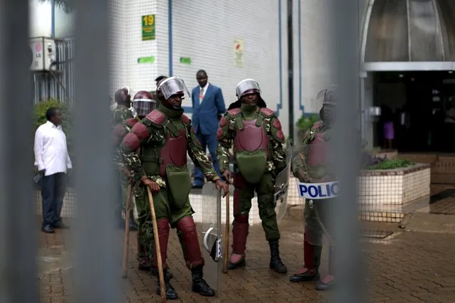 Kenyan anti riot police guard the premises of the country's electoral commission after a crowd consisting of opposition leaders and their supporters tried to enter the building to demand the disbandment of the electoral body ahead of next year's election in Nairobi, Kenya, April 25, 2016. (Photo by Siegfried Modola/Reuters)