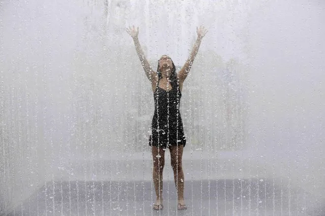 Maria Romana from Spain poses for photographers as she cools off in a fountain on a hot Summer day in London, Britain July 1, 2015. (Photo by Paul Hackett/Reuters)