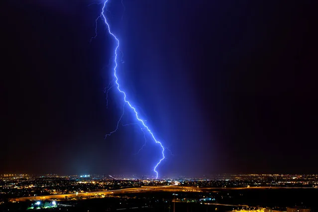 A lightning bolt strikes in the middle of Tucson city during the summer monsoons in July 2012. (Photo by Mike Olbinski/Barcroft Media)