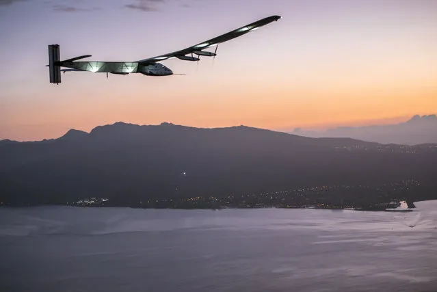 Solar Impulse 2, a plane powered by the sun's rays and piloted by Andre Borschberg, approaches Kalaeloa Airport near Honolulu, Friday, July 3, 2015. His 120-hour voyage from Nagoya, Japan broke the record for the world's longest nonstop solo flight, his team said. (Photo by Jean Revillard/Global Newsroom via AP Photo)