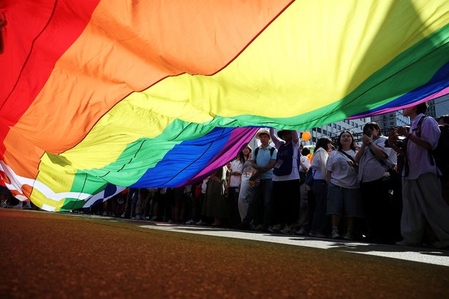 Participants stand behind a huge rainbow flag during the Seoul Queer Culture Festival in Seoul, South Korea, on June 1, 2024. (Photo by Kim Hong-Ji/Reuters)
