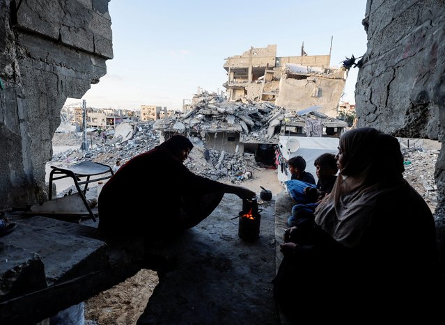 Palestinians sit at their house which was destroyed in an Israeli strike in Khan Younis, in the southern Gaza Strip, on May 29, 2024. (Photo by Mohammed Salem/Reuters)
