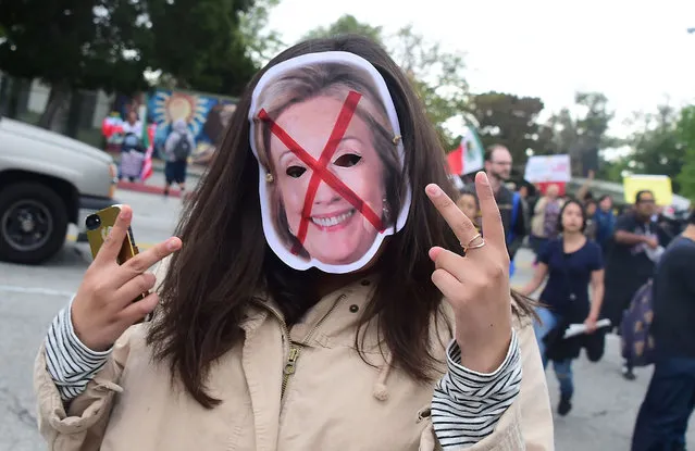 Protesters from Latino and Community groups make their way to East Los Angeles College in Monterey Park, California ,on May 5, 2016, to protest US Democratic presidential candidate Hillary Clinton. Clinton campaigned in the Los Angeles ahead of California's June 7 primary. (Photo by Frederic J. Brown/AFP Photo)